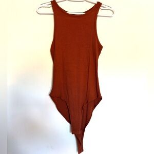 Brand is Selfie, size small, color is burnt orange. The material is ribbed.